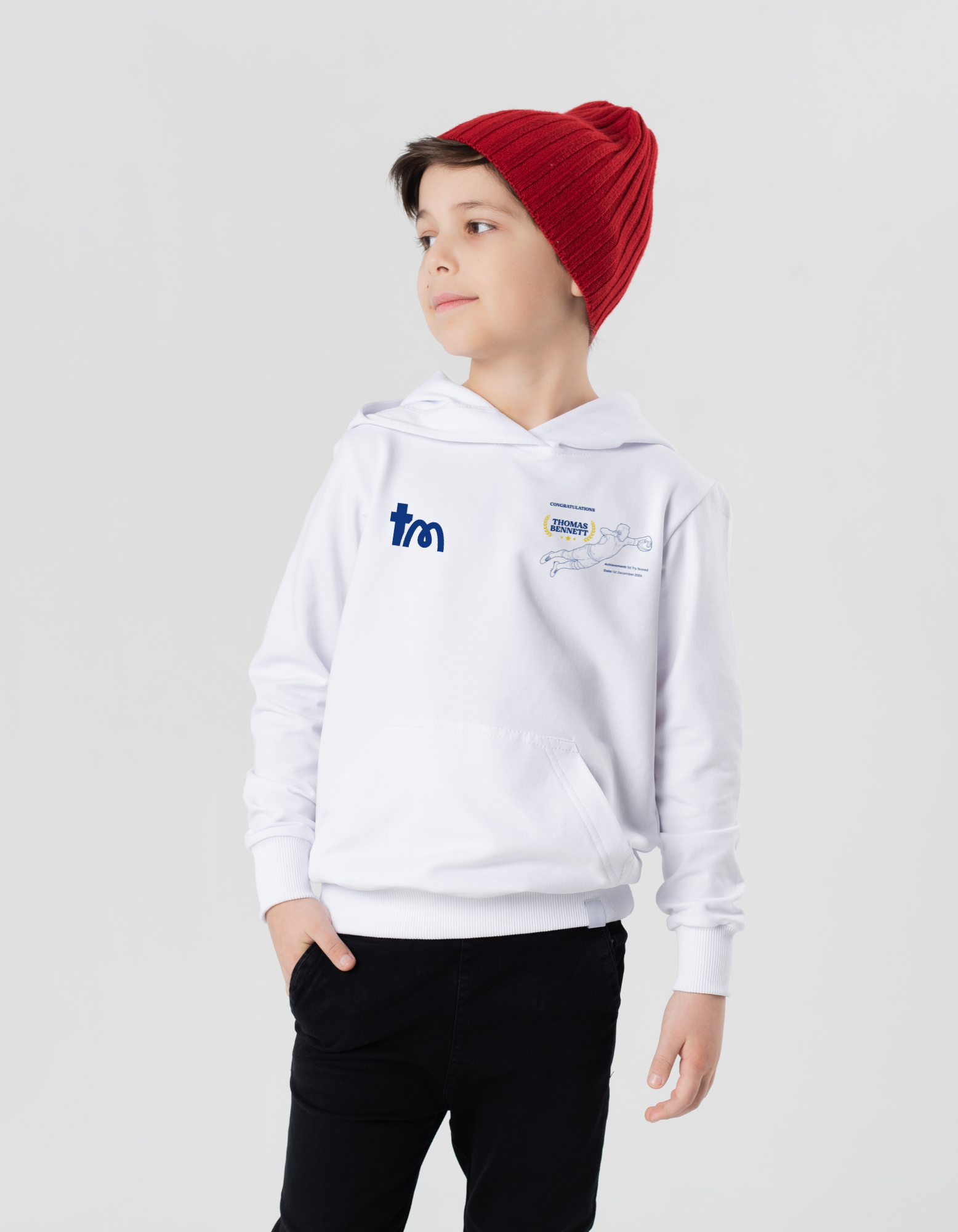 Child wearing a white hoodie with logos on a light gray background showcasing a TeeMemento product