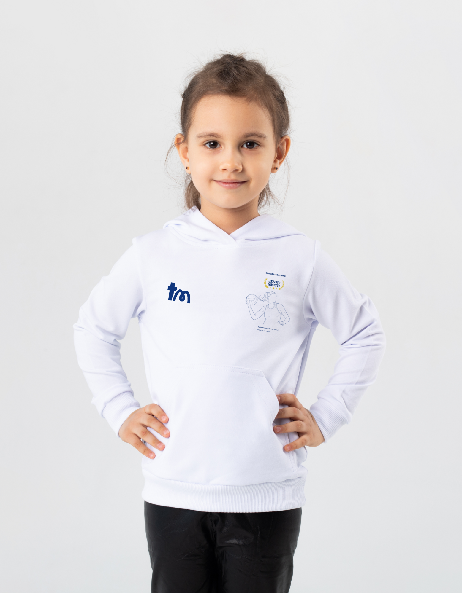 A young girl wearing a white hoodie showcasing a TeeMemento product 