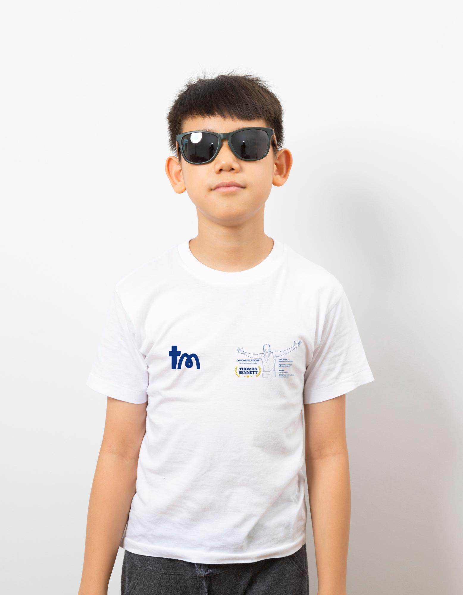 Person wearing a white t-shirt with logos on a plain background - showing the TeeMemento athletics motif and personalisation