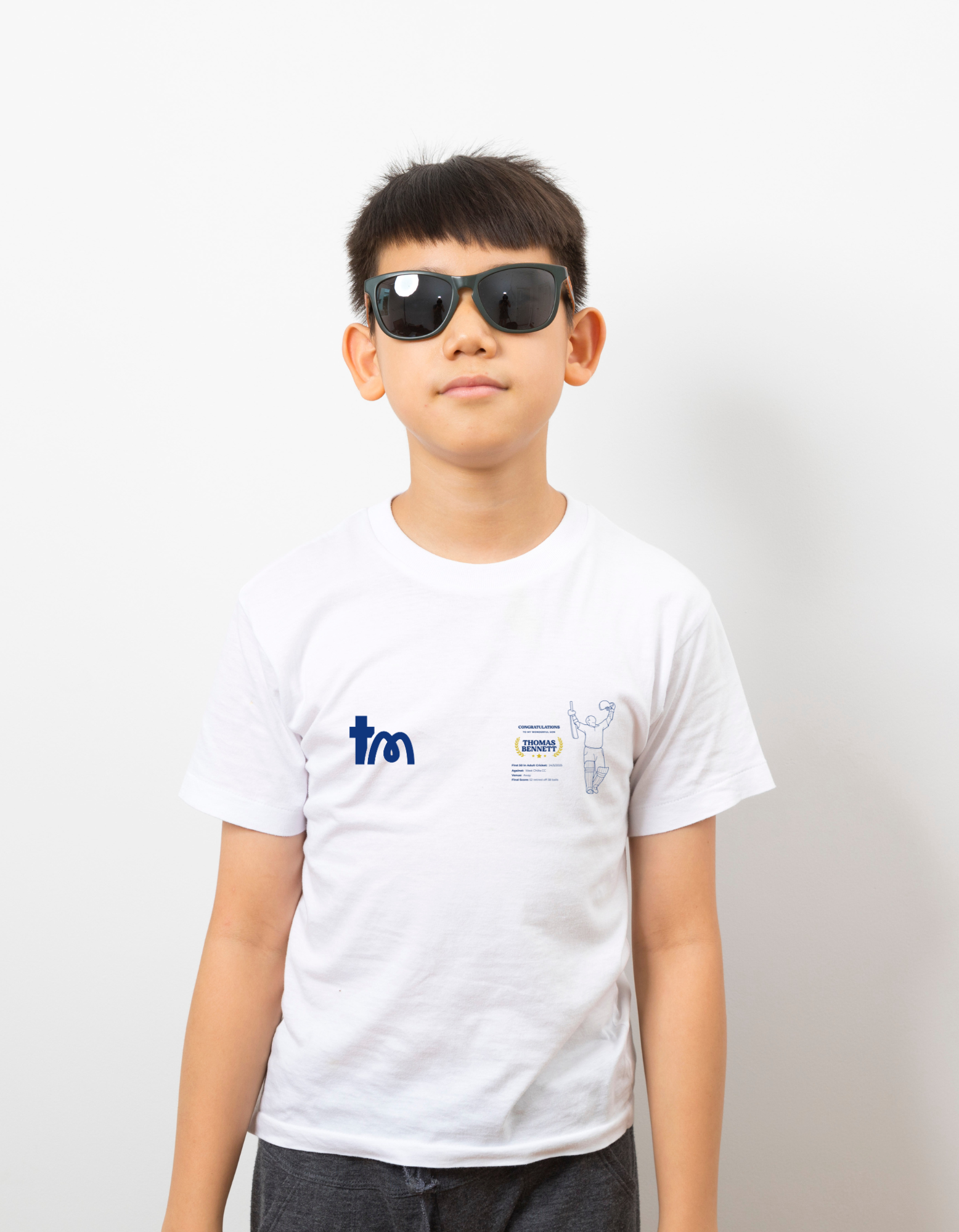Person wearing a white t-shirt with a logo on a plain background - showing the TeeMemento cricket motif and personalisation