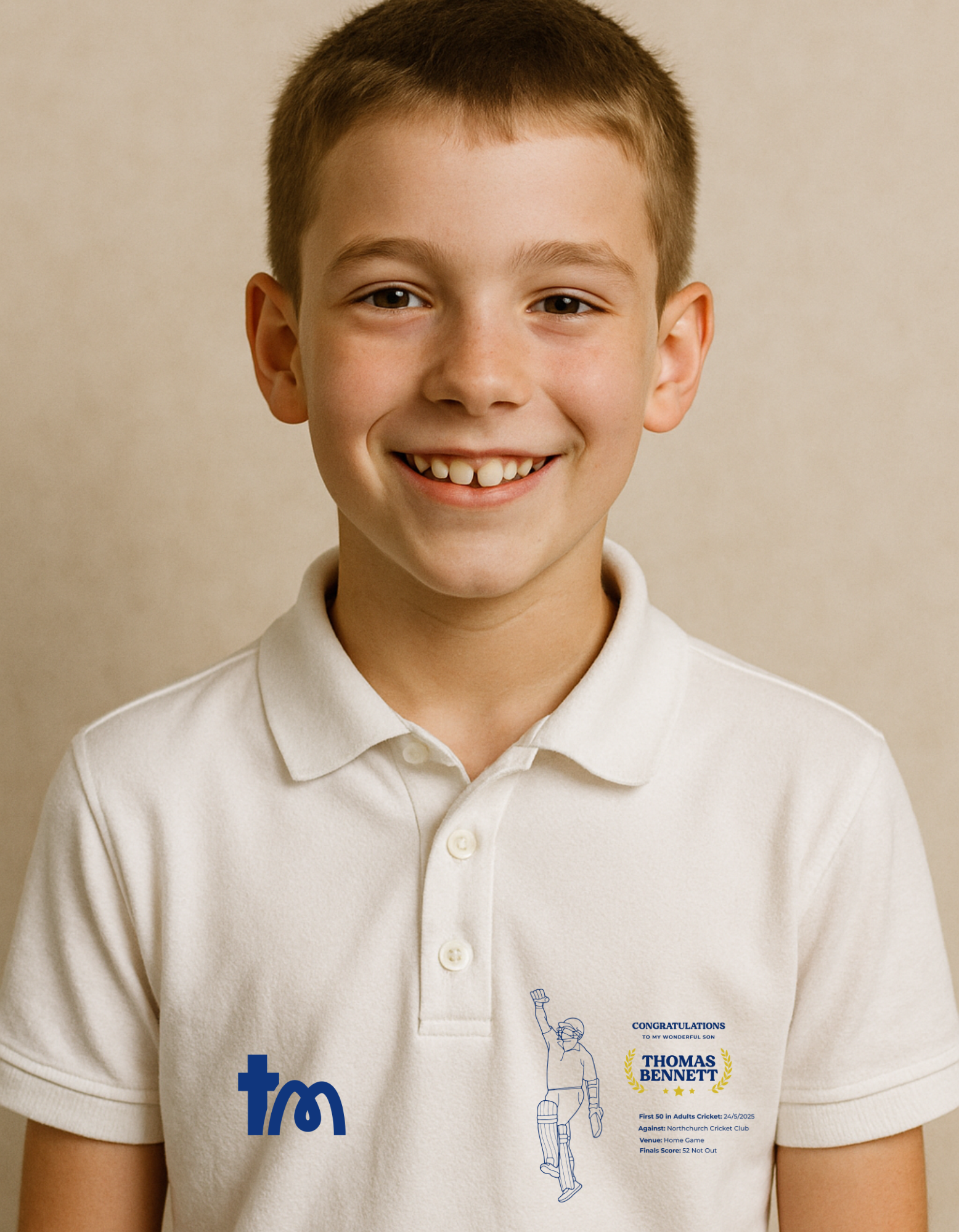 Young boy wearing a white polo shirt with logos on a beige background - showing the TeeMemento cricket motif and personalisation