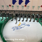 Embroidery machine in action completing a TeeMemento product order