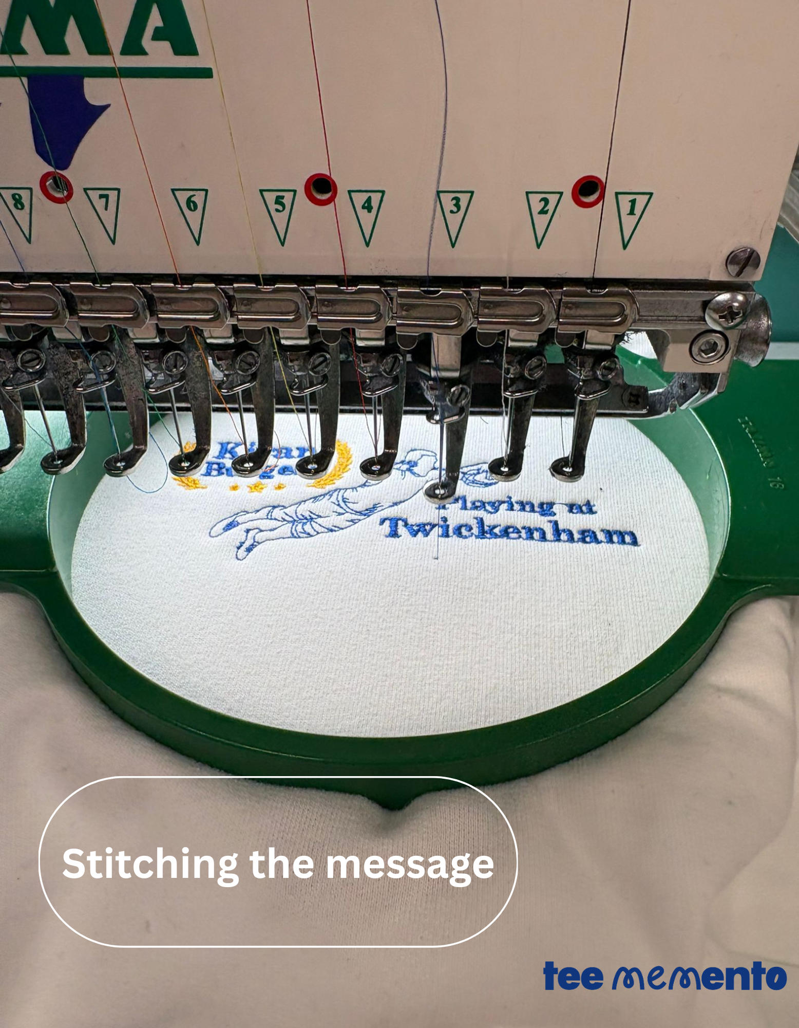 Embroidery machine with a message on a white fabric, featuring the brand 'teememento'.